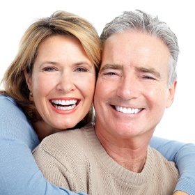 An older woman and man hugging and smiling