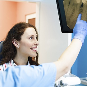 Smiling woman looking at x-rays