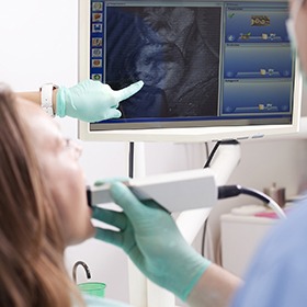 Woman and dentist looking at intraoral photos